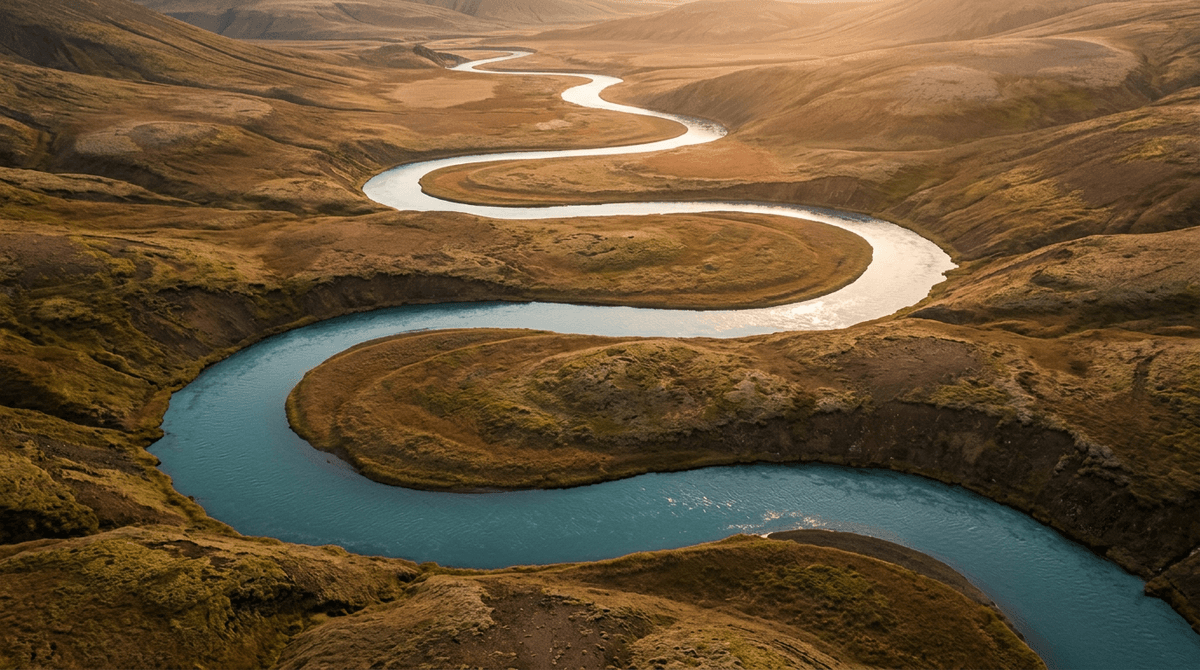 A winding river flowing through a serene landscape in golden hour light, representing natural flexibility